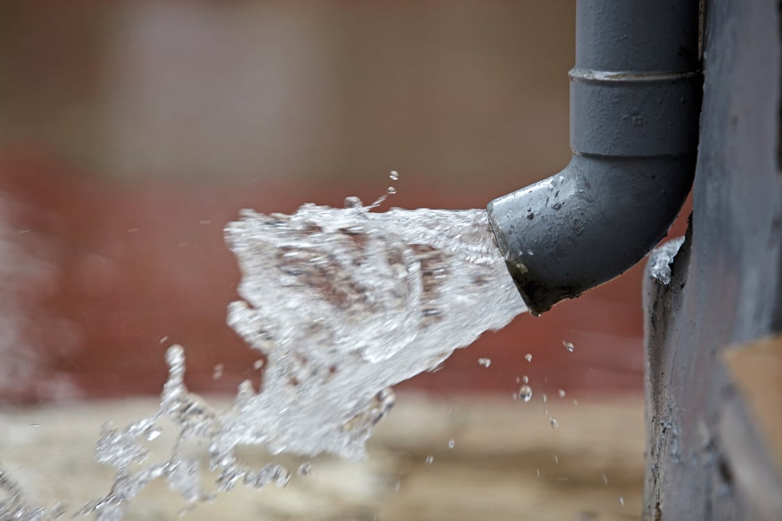 Rain Water Flowing from Plastic Gutter.